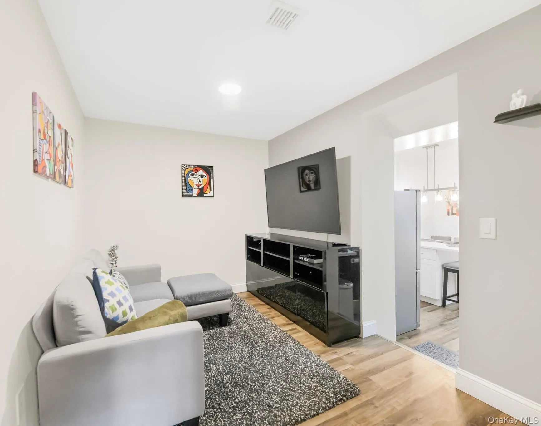 Living room featuring light wood-style flooring and recessed lighting Living room featuring light wood-style flooring and recessed lighting
