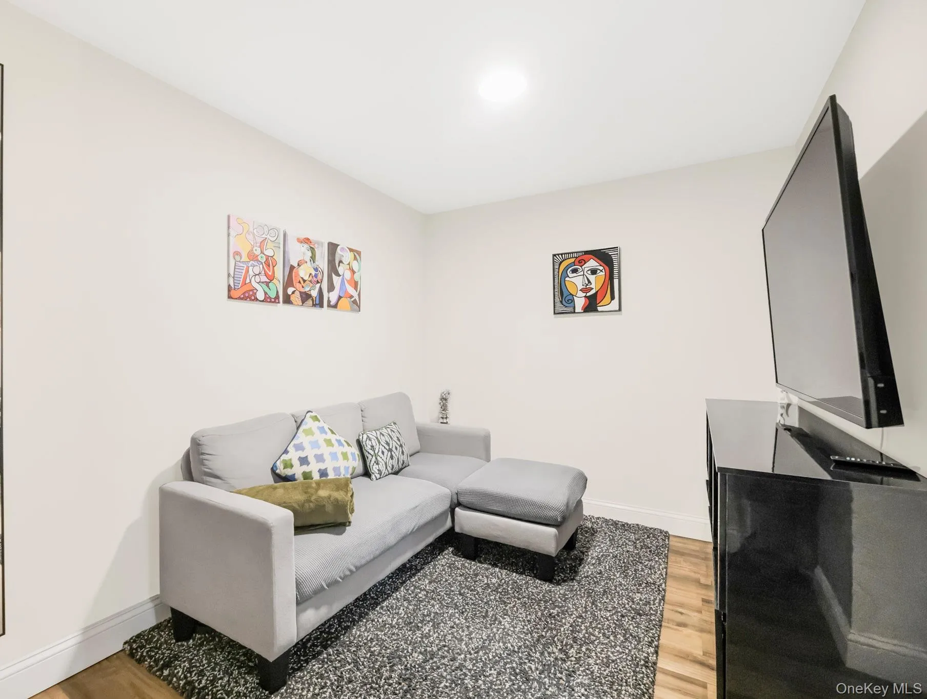 Living area with light wood finished floors and baseboards Living area with light wood finished floors and baseboards