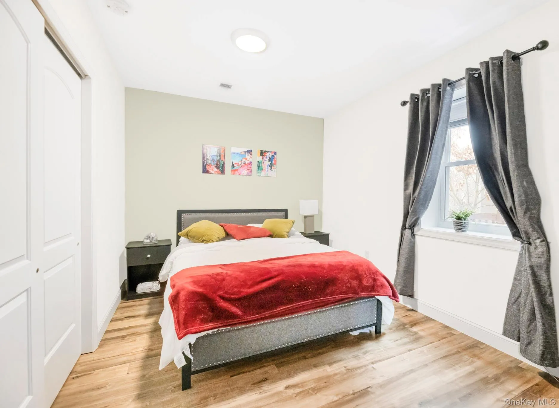 Bedroom with light wood-style flooring and a closet Bedroom with light wood-style flooring and a closet