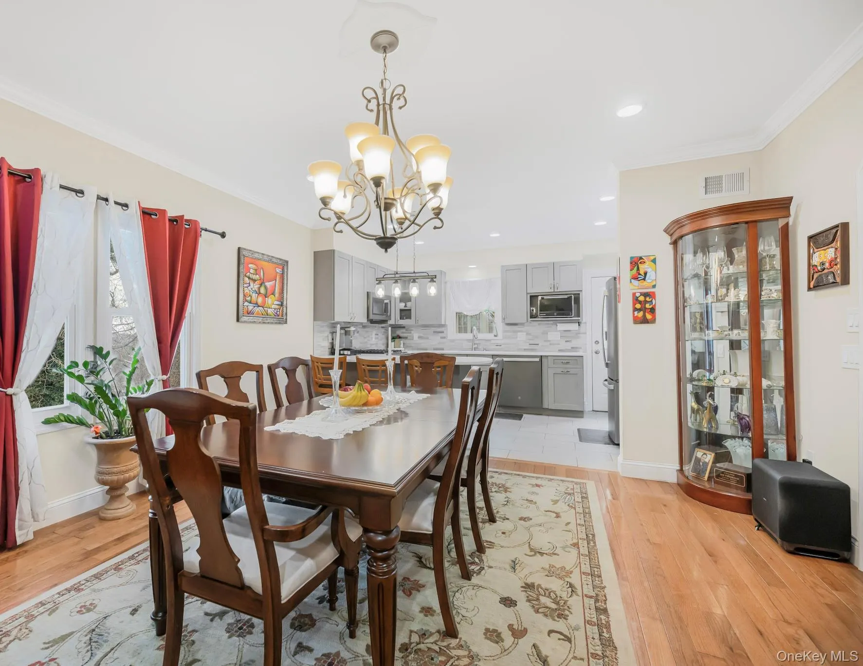 Dining room featuring crown molding, a chandelier, light wood finished floors, and recessed lighting Dining room featuring crown molding, a chandelier, light wood finished floors, and recessed lighting
