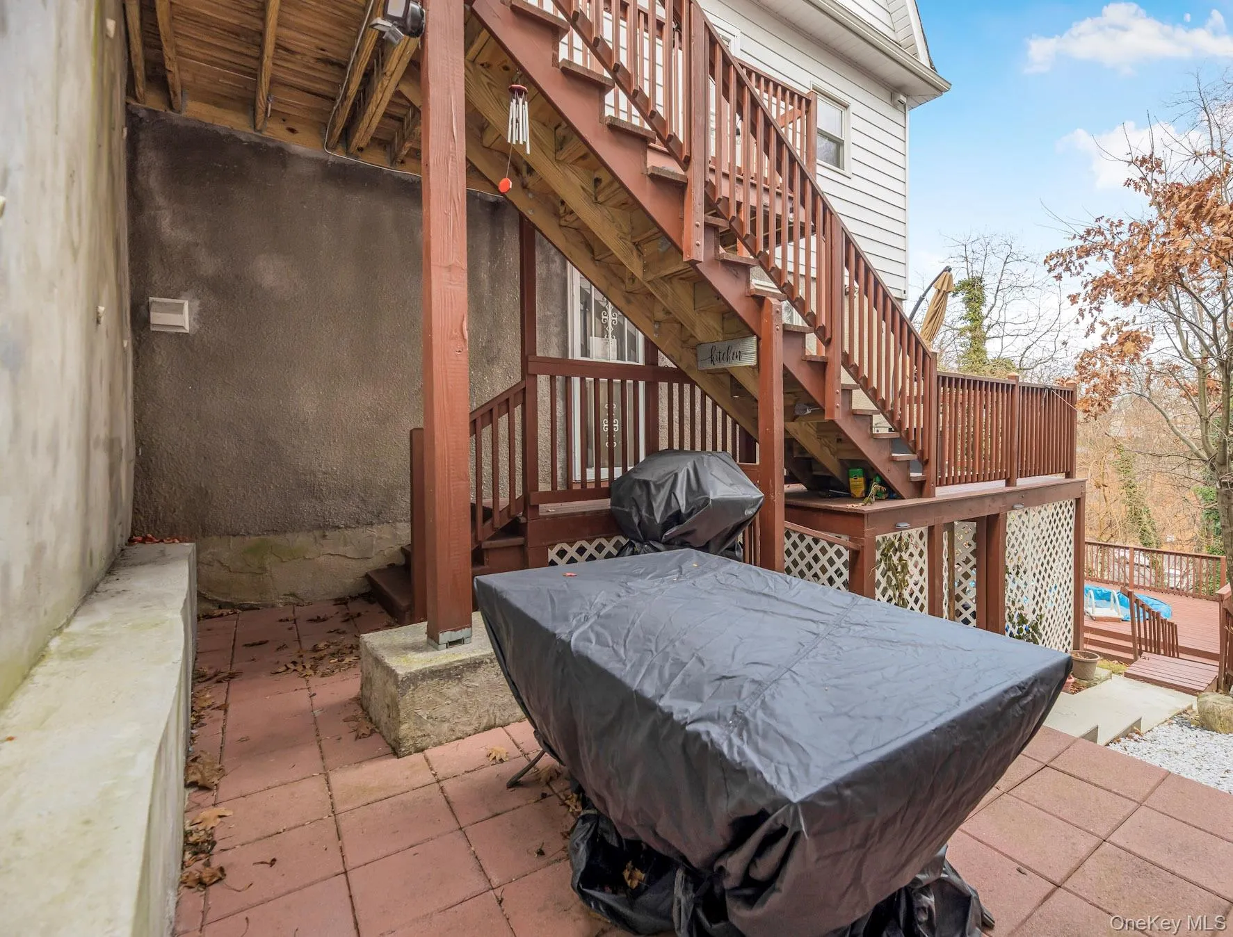 View of patio with stairs, a deck, and a grill View of patio with stairs, a deck, and a grill