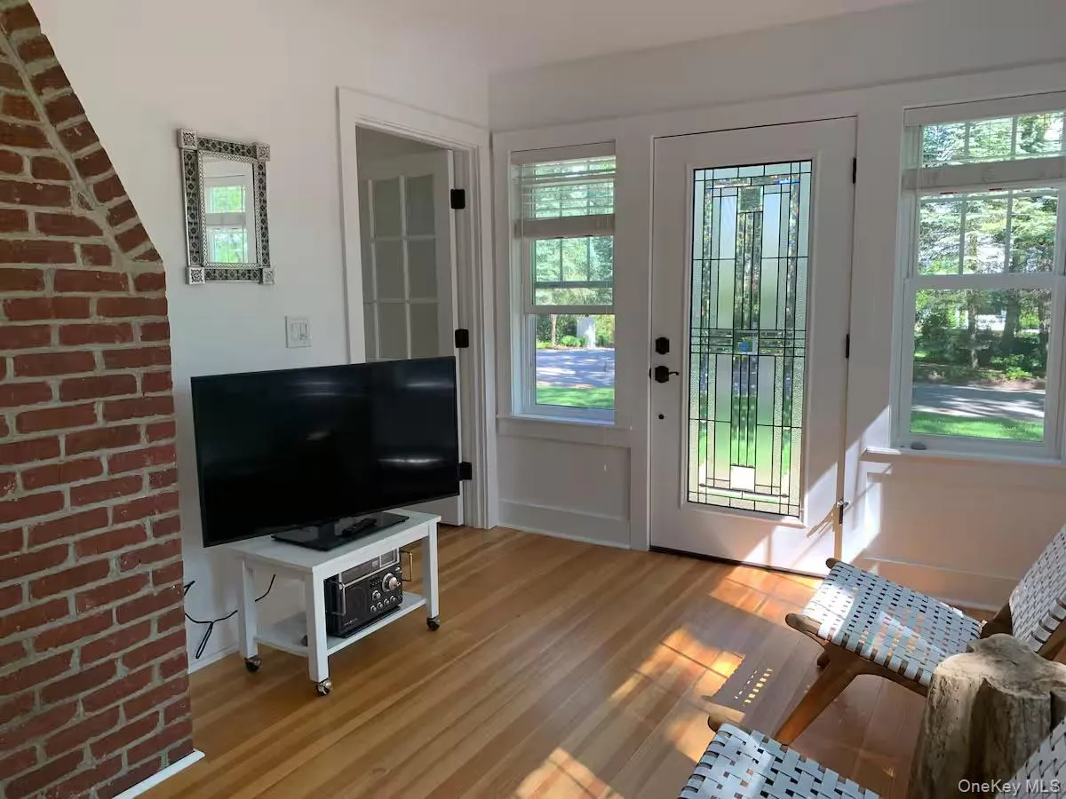 Doorway to outside featuring wood finished floors Doorway to outside featuring wood finished floors