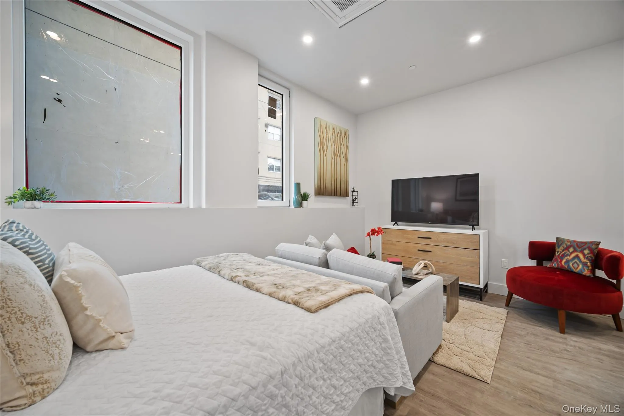Bedroom with wood finished floors, cooling unit, and recessed lighting Bedroom with wood finished floors, cooling unit, and recessed lighting