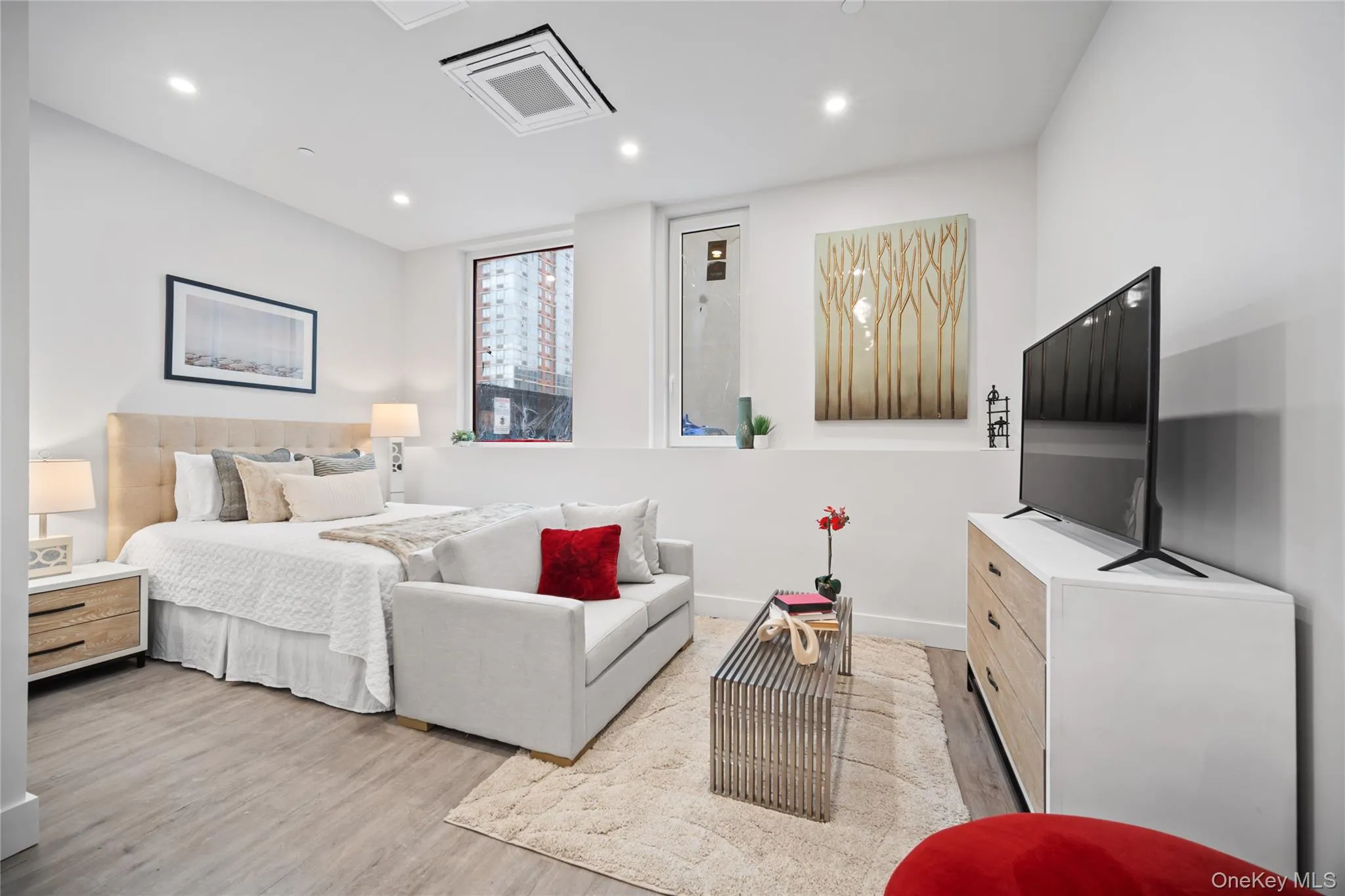 Bedroom featuring cooling unit, light wood finished floors, and recessed lighting Bedroom featuring cooling unit, light wood finished floors, and recessed lighting