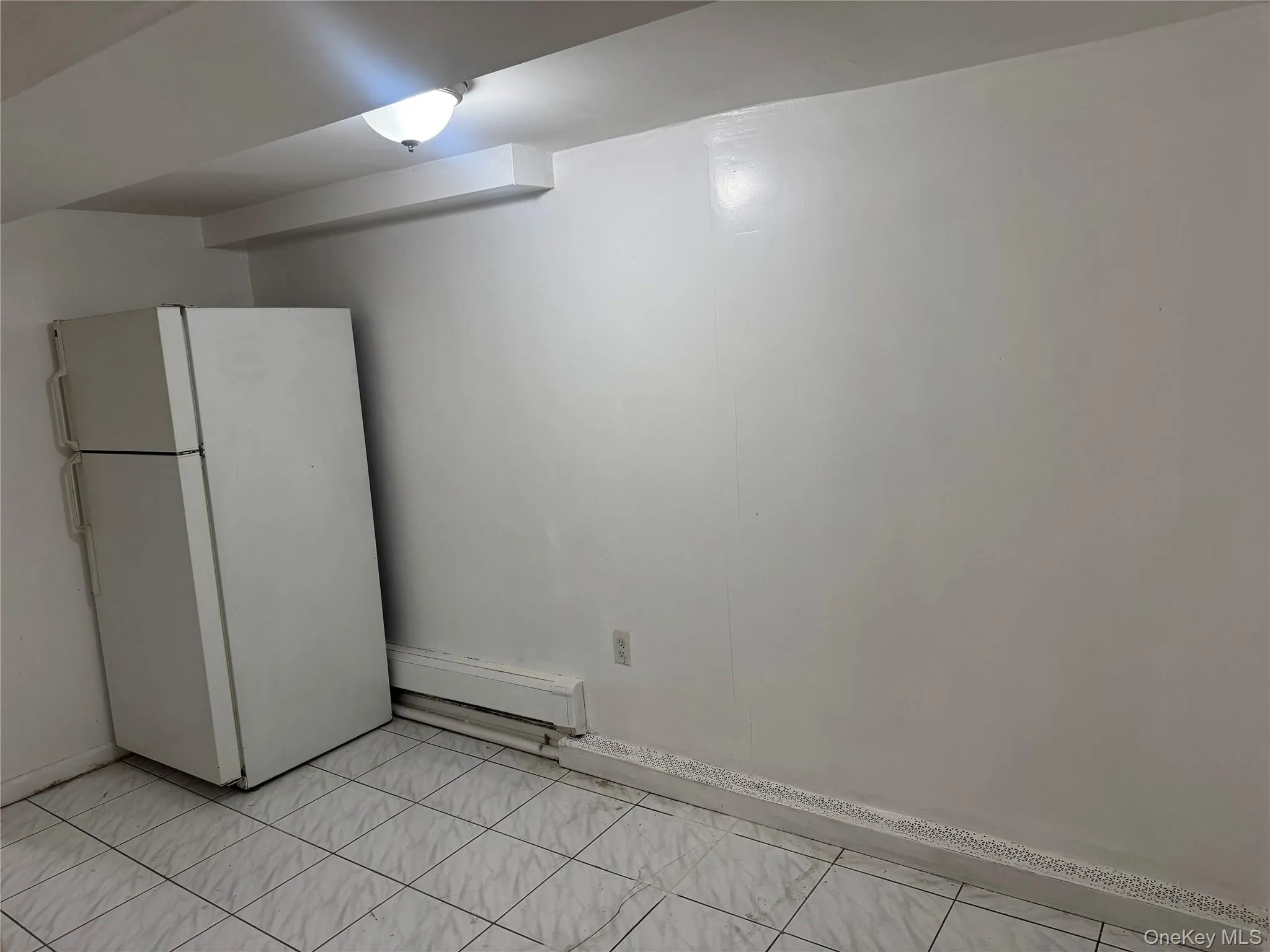 Empty room featuring a baseboard radiator Empty room featuring a baseboard radiator