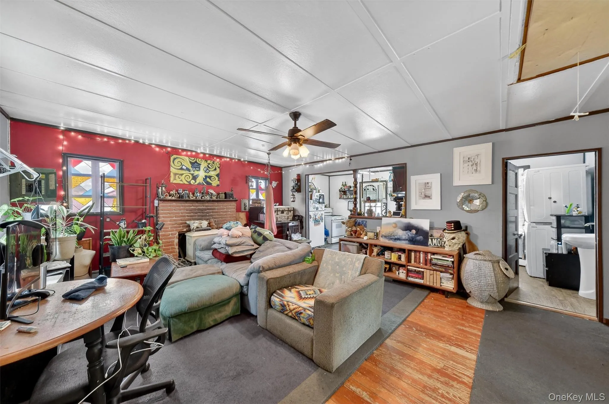 Living area featuring wood finished floors and a ceiling fan Living area featuring wood finished floors and a ceiling fan