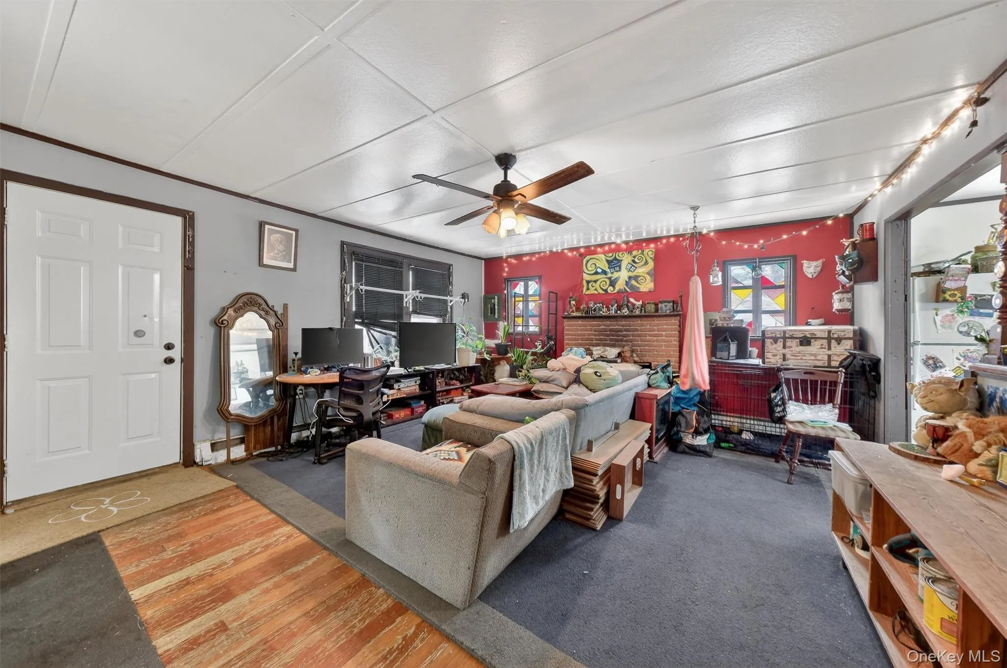 Living area featuring ceiling fan and wood finished floors Living area featuring ceiling fan and wood finished floors