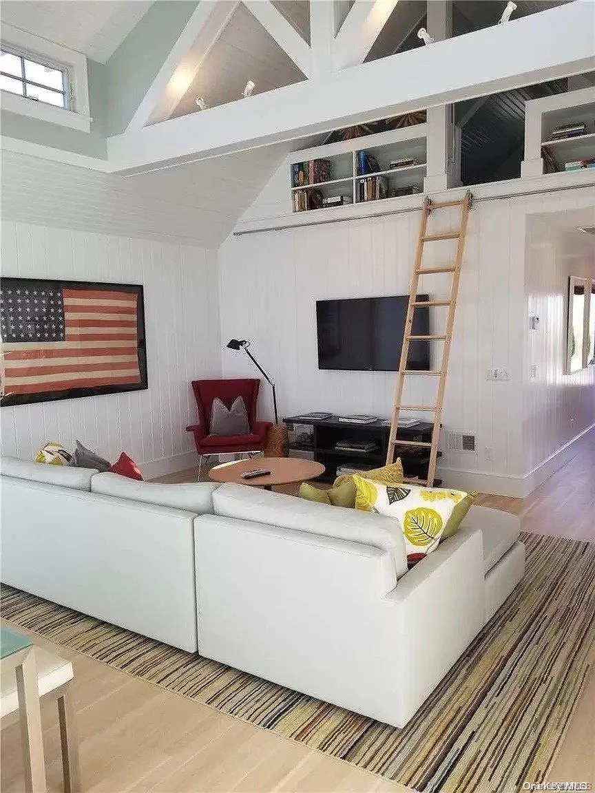 Living area featuring wood walls and wood finished floors Living area featuring wood walls and wood finished floors