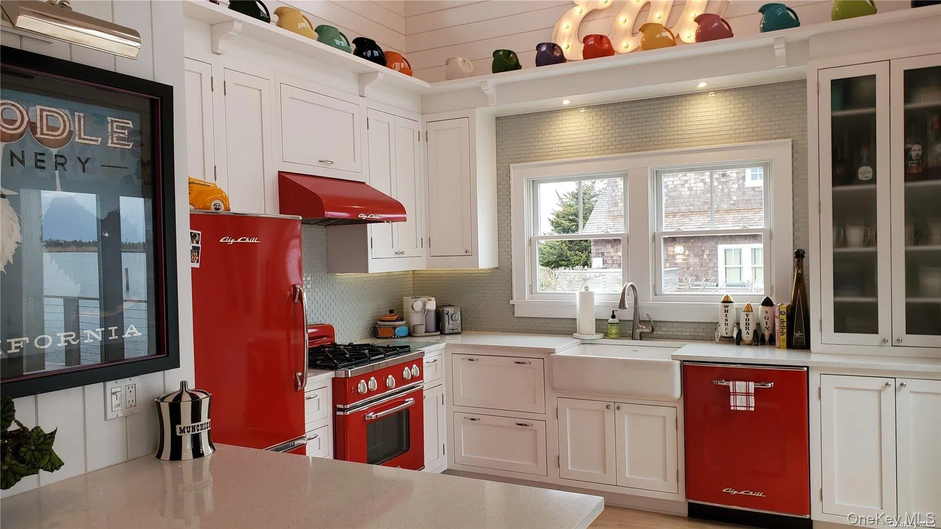 Kitchen with white cabinetry, dishwasher, gas stove, and under cabinet range hood Kitchen with white cabinetry, dishwasher, gas stove, and under cabinet range hood
