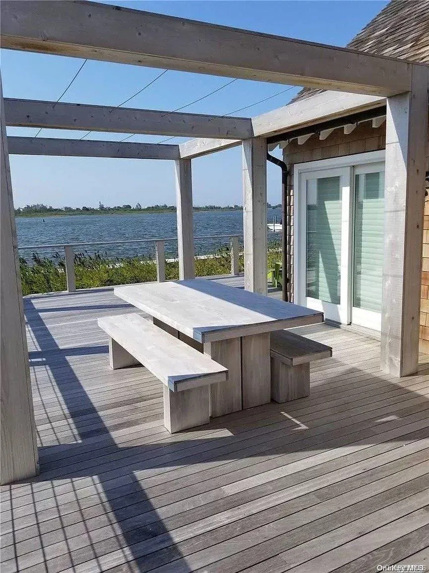 Wooden terrace featuring a water view Wooden terrace featuring a water view
