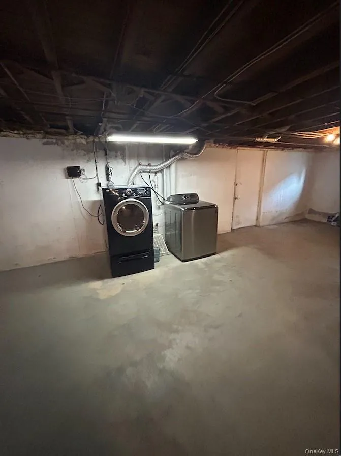 Unfinished below grade area featuring separate washer and dryer Unfinished below grade area featuring separate washer and dryer