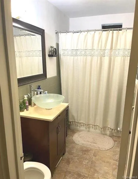 Bathroom featuring vanity and toilet Bathroom featuring vanity and toilet