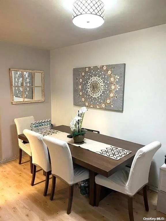 Dining room with light wood-type flooring Dining room with light wood-type flooring