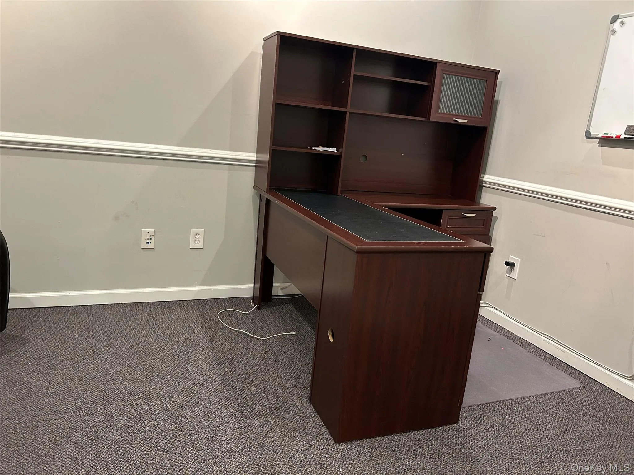 Unfurnished office featuring dark carpet Unfurnished office featuring dark carpet