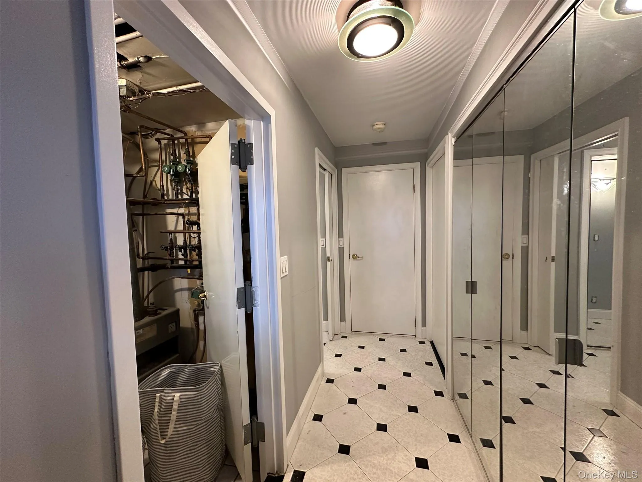 Hallway with baseboards and light tile patterned flooring Hallway with baseboards and light tile patterned flooring