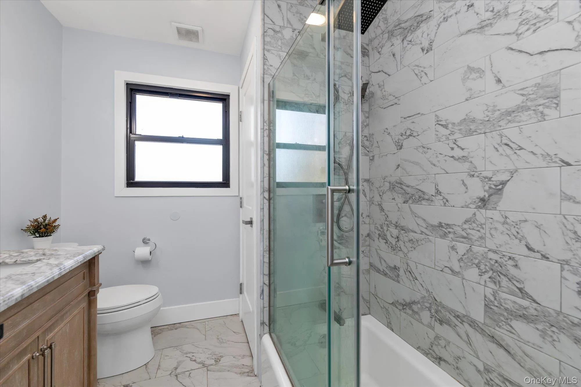 Full bath featuring bath / shower combo with glass door Full bath featuring bath / shower combo with glass door