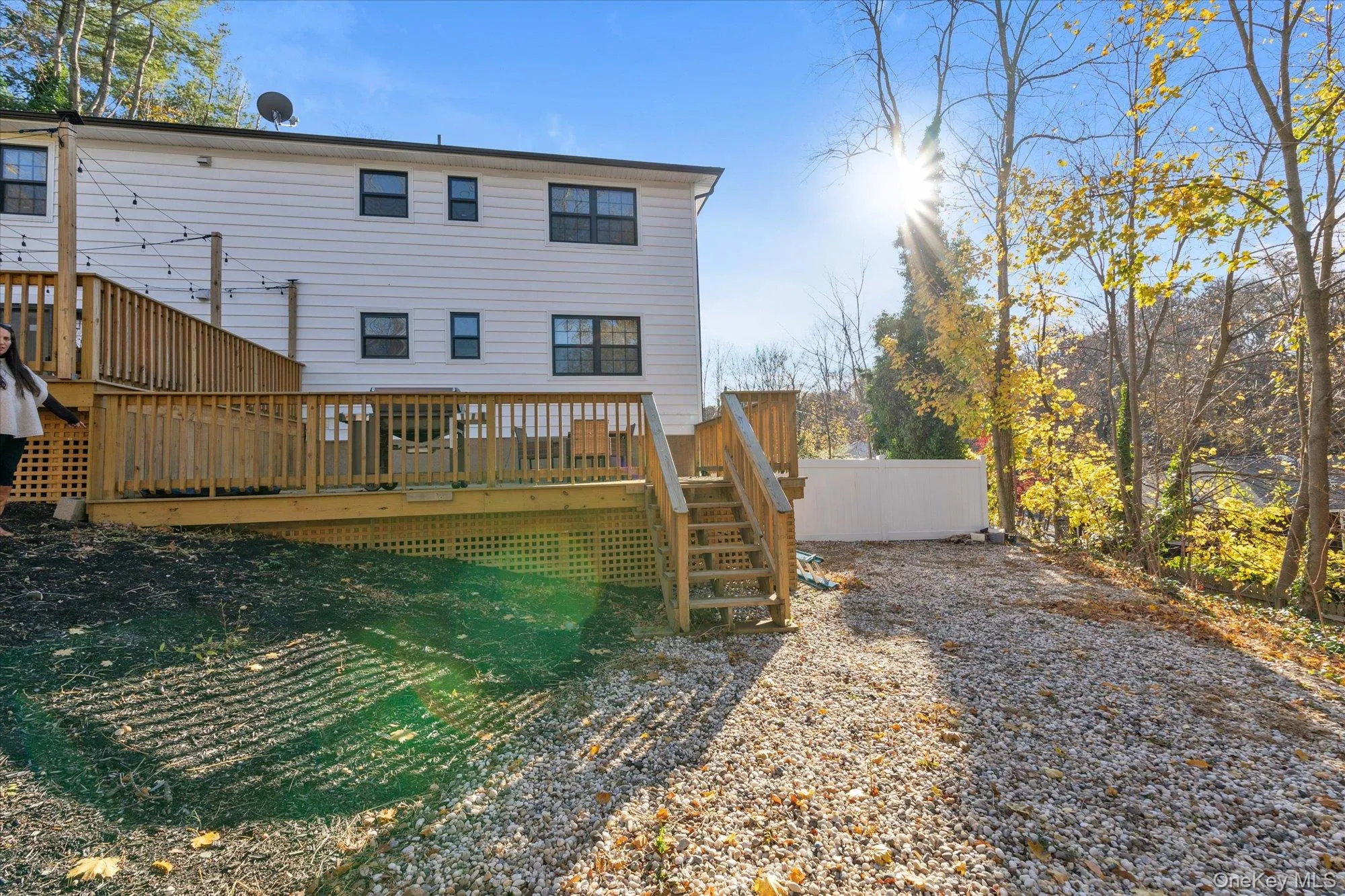 Rear view of house featuring a deck and yardspace Rear view of house featuring a deck and yardspace
