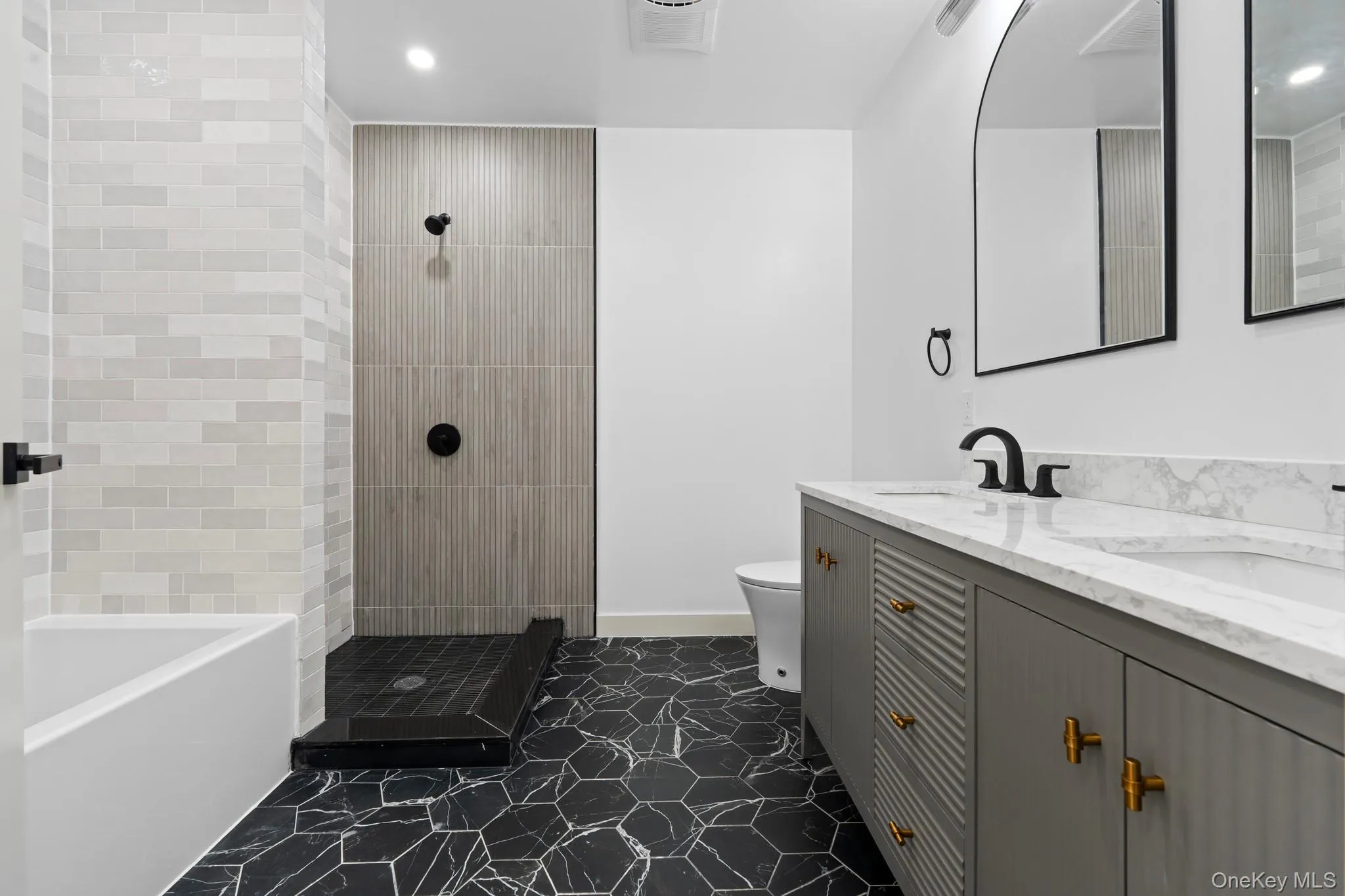 Full bathroom with double vanity, a bath, a walk in shower, and recessed lighting Full bathroom with double vanity, a bath, a walk in shower, and recessed lighting