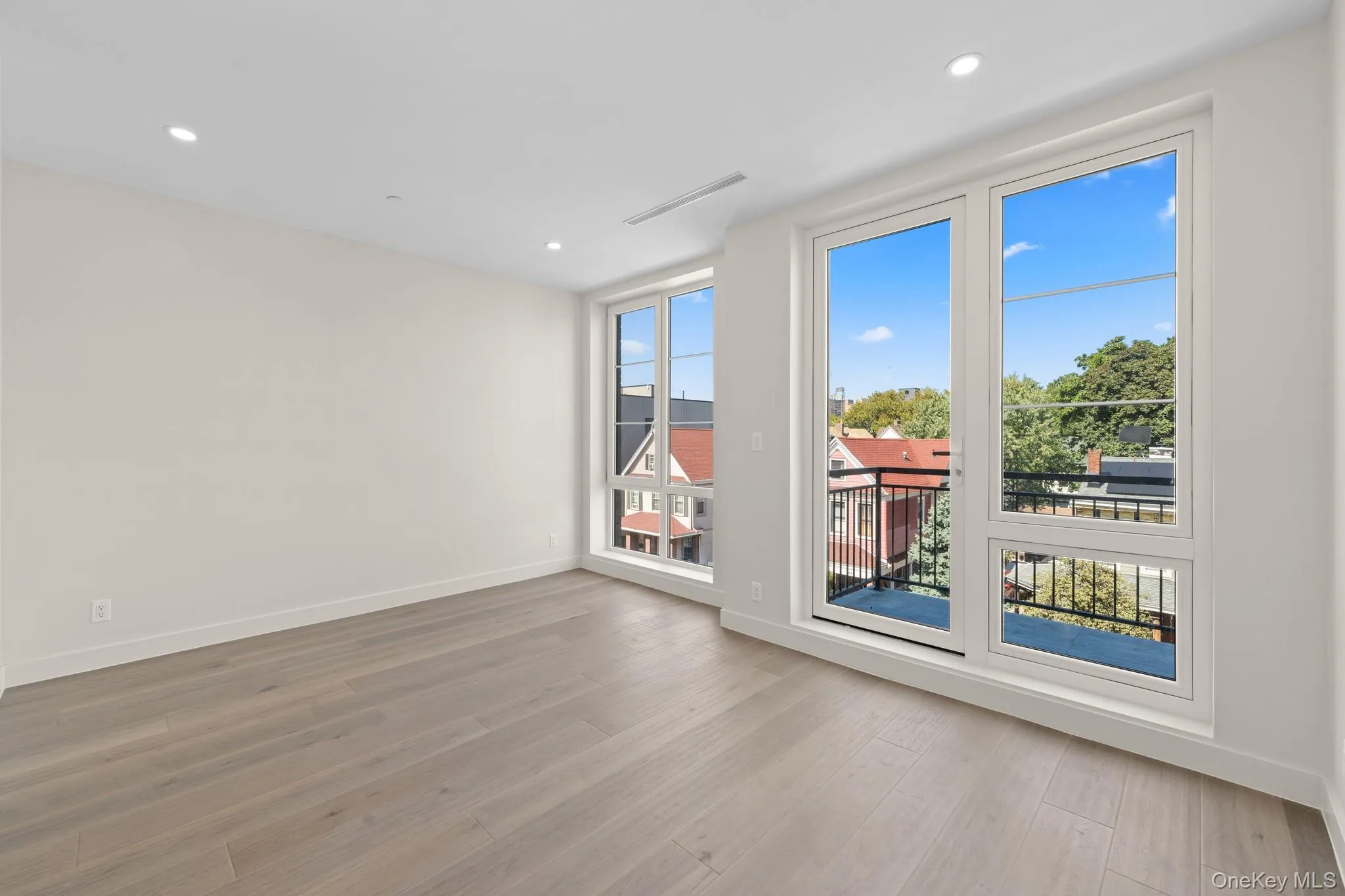Spare room with light wood finished floors and recessed lighting Spare room with light wood finished floors and recessed lighting