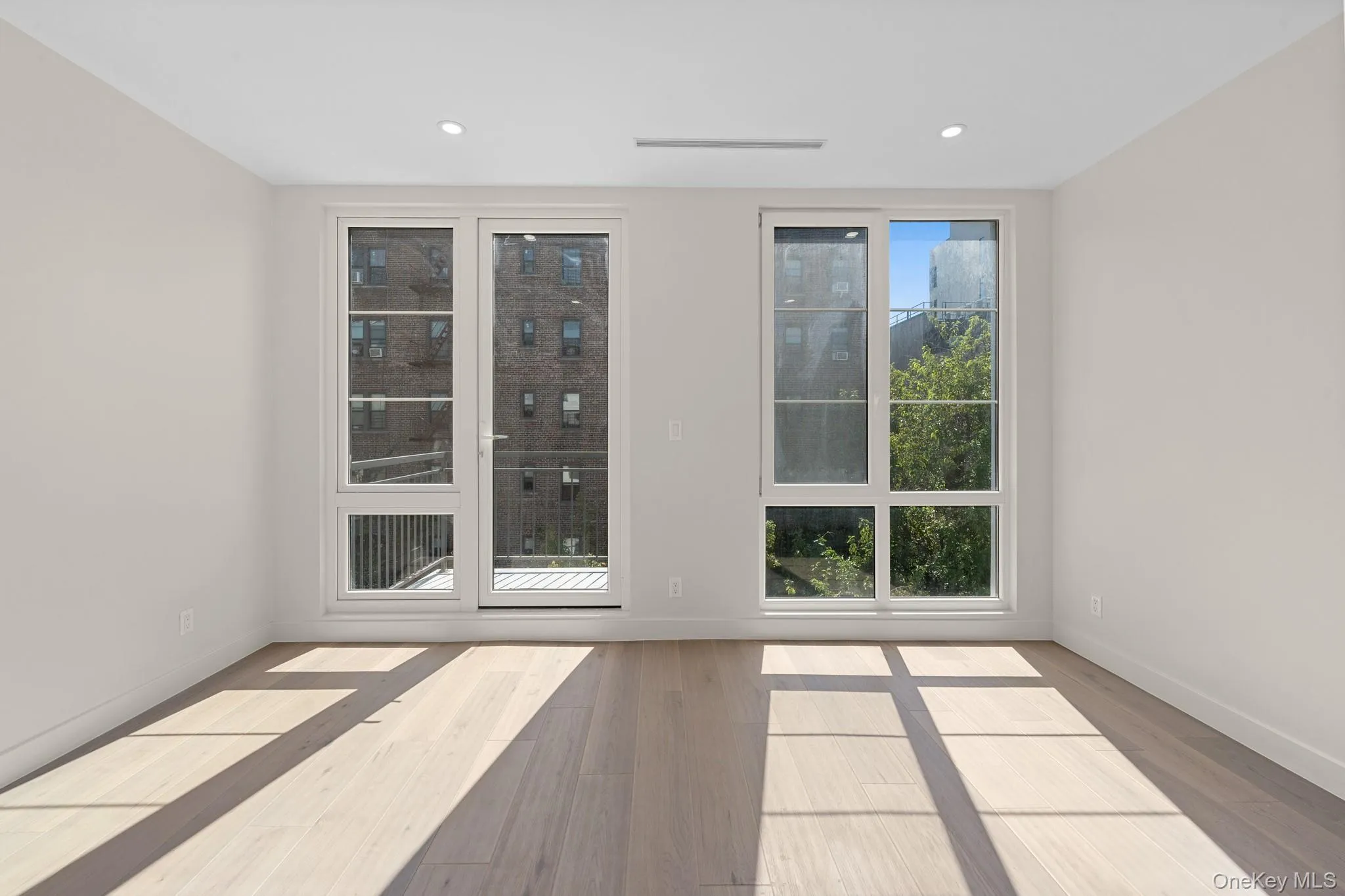 Spare room featuring wood finished floors and recessed lighting Spare room featuring wood finished floors and recessed lighting
