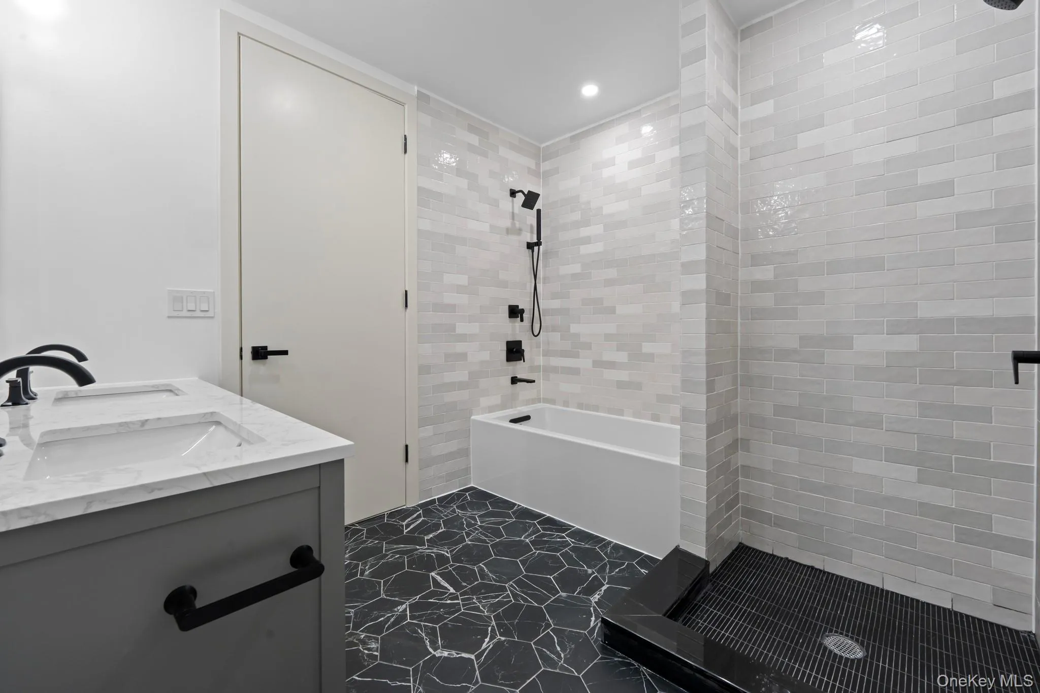 Full bathroom with double vanity, recessed lighting, and tiled shower / bath Full bathroom with double vanity, recessed lighting, and tiled shower / bath