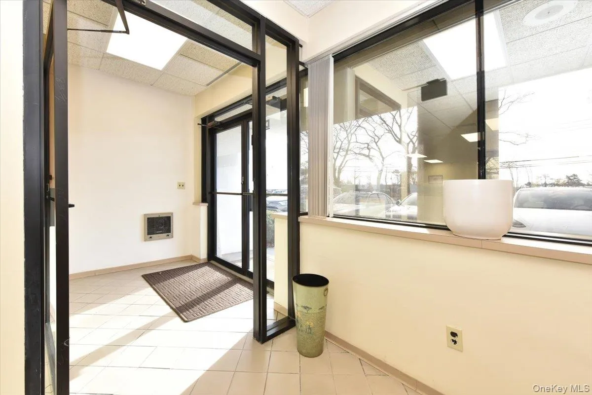 Doorway with a paneled ceiling, heating unit, and tile patterned floors Doorway with a paneled ceiling, heating unit, and tile patterned floors