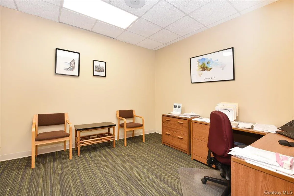 Office area with a paneled ceiling Office area with a paneled ceiling