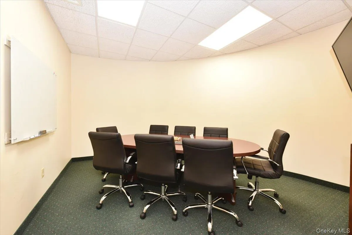 Office featuring a paneled ceiling and carpet floors Office featuring a paneled ceiling and carpet floors