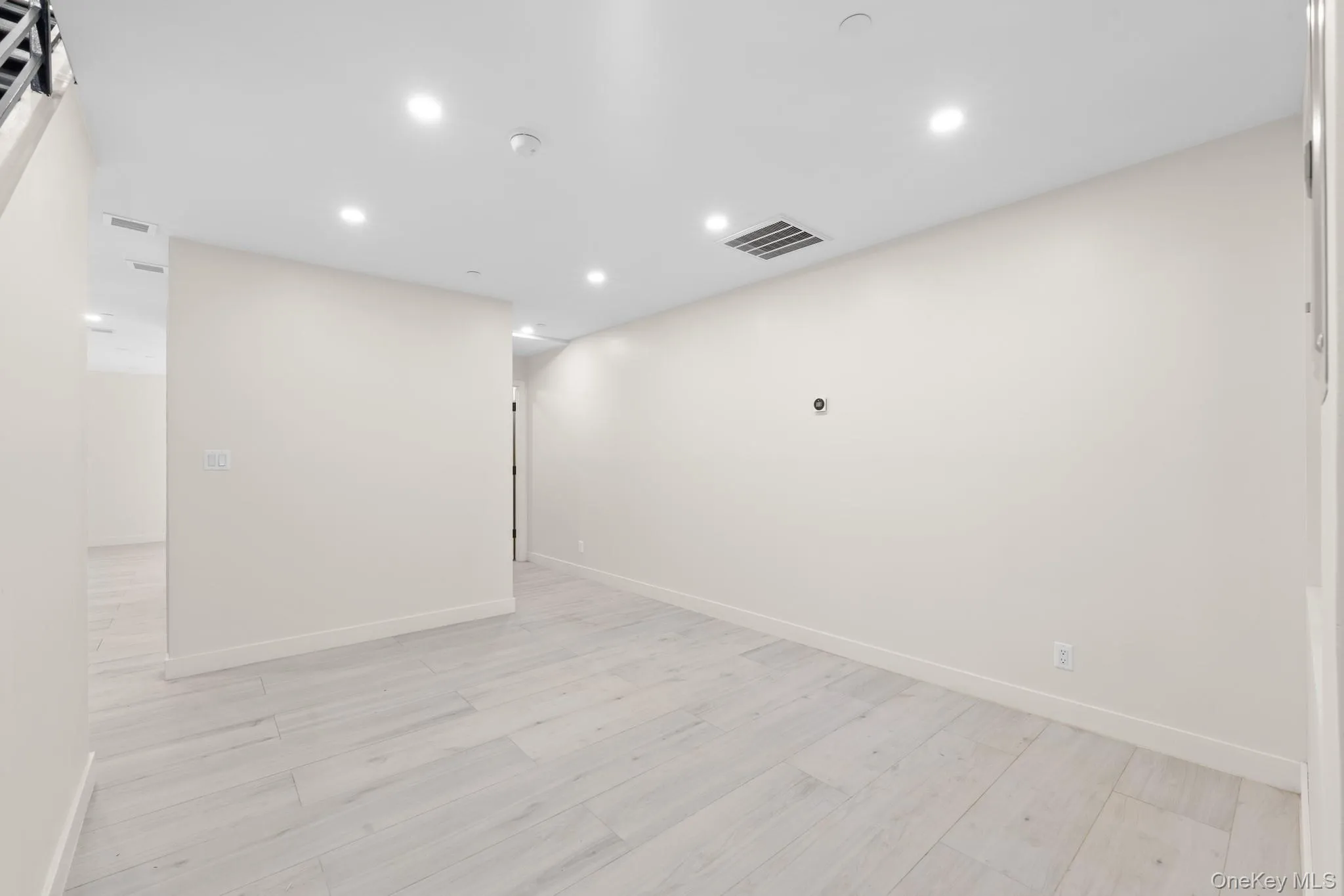 Unfurnished room featuring recessed lighting and light wood-style flooring Unfurnished room featuring recessed lighting and light wood-style flooring