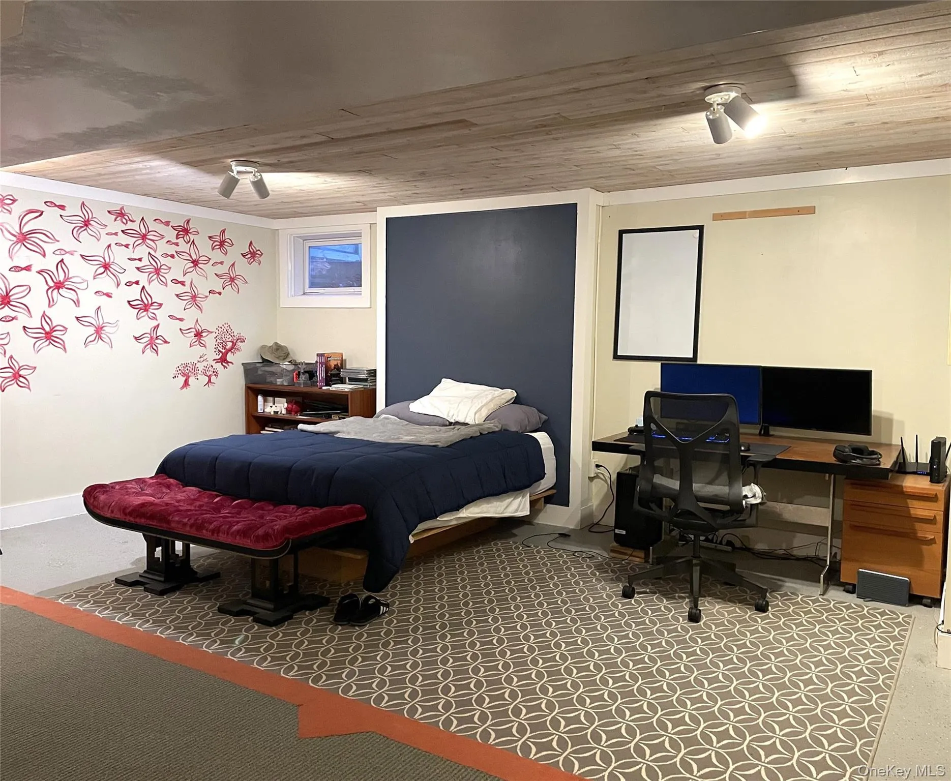 Bedroom featuring wooden ceiling, ceiling fan, and a desk