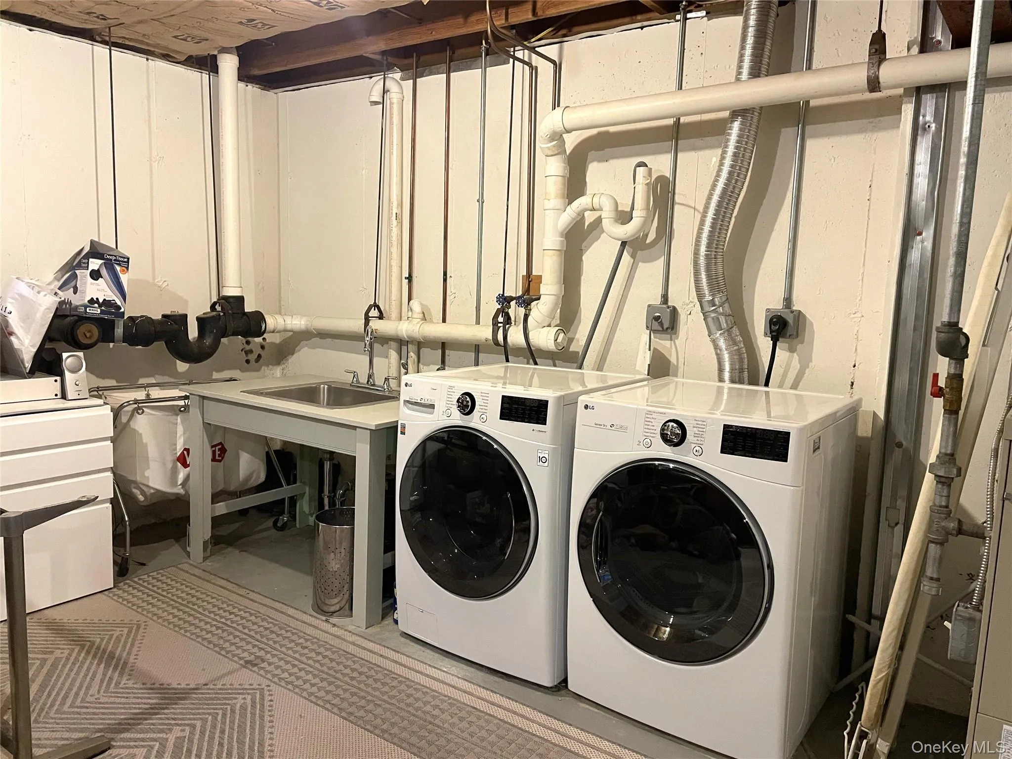 Laundry area featuring concrete floors and independent washer and dryer