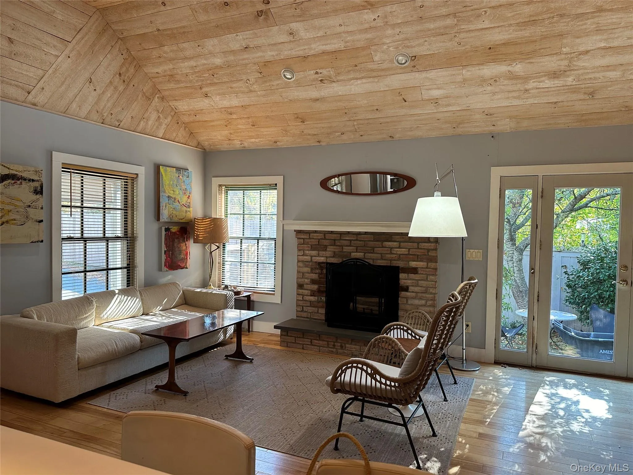 Living area with wood ceiling, a fireplace, wood-type flooring, and vaulted ceiling