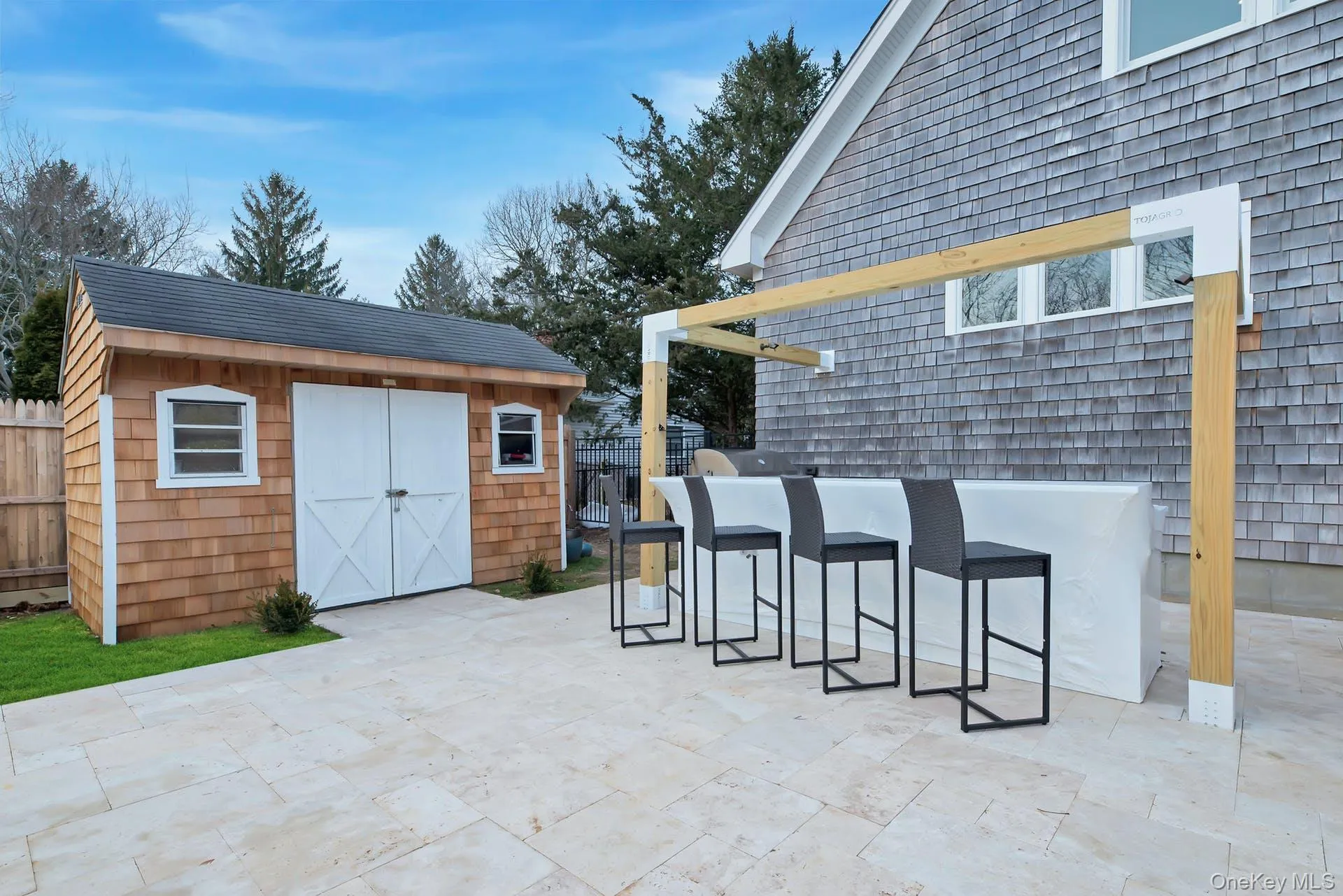 View of patio with a storage unit and area for grilling View of patio with a storage unit and area for grilling