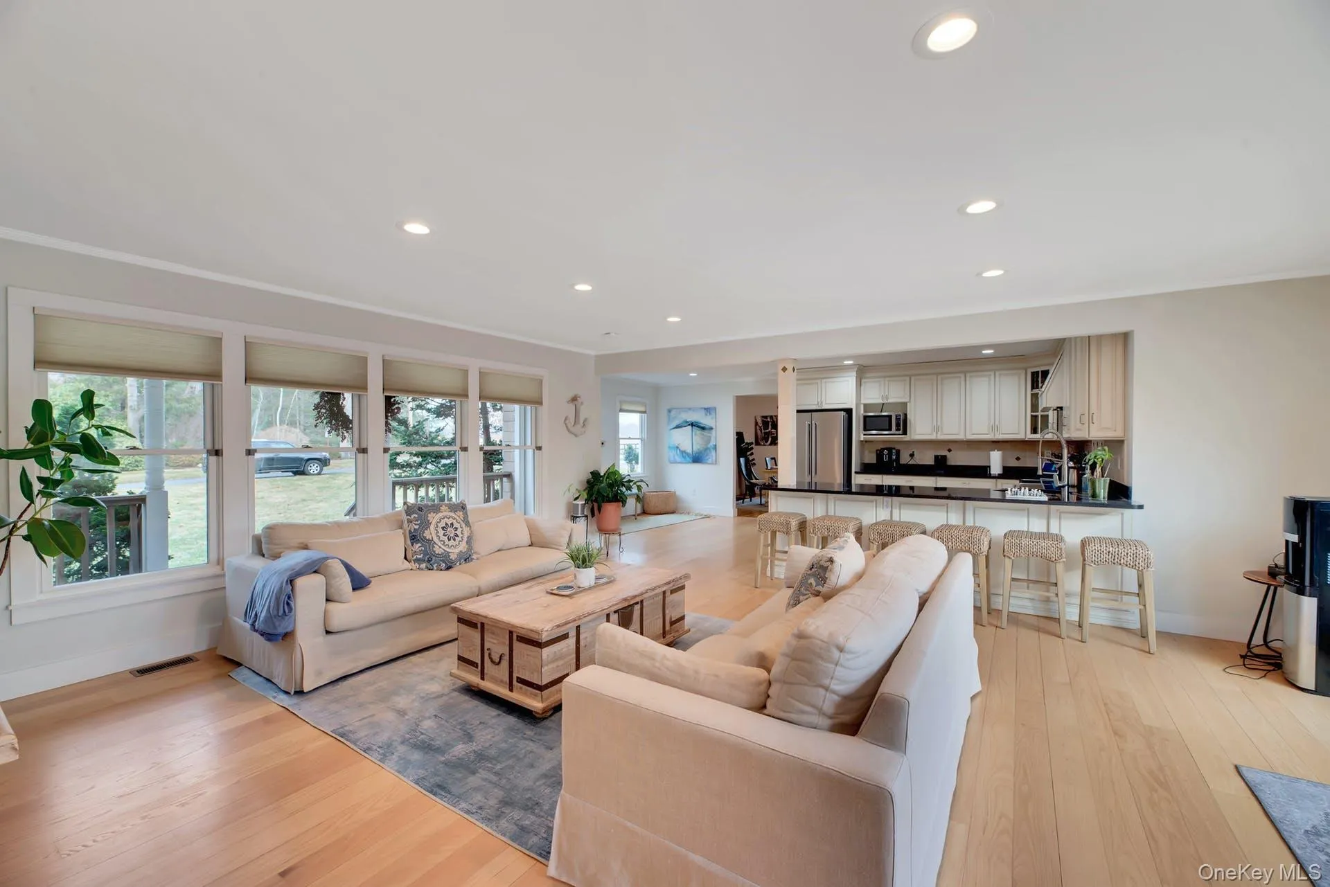 Living area with healthy amount of natural light, recessed lighting, light wood finished floors, and crown molding Living area with healthy amount of natural light, recessed lighting, light wood finished floors, and crown molding