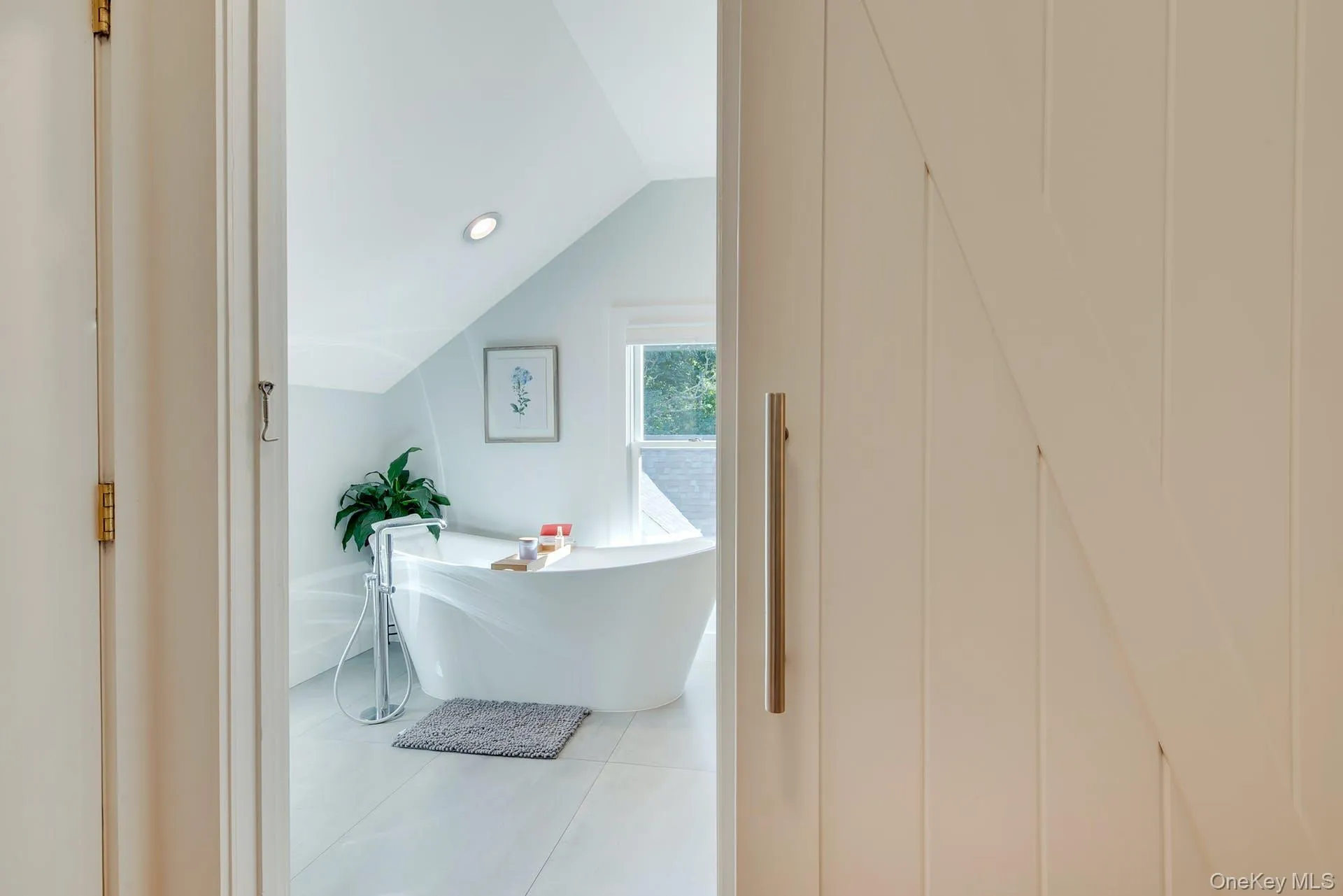 Bathroom featuring vaulted ceiling, a freestanding bath, tile patterned flooring, and recessed lighting Bathroom featuring vaulted ceiling, a freestanding bath, tile patterned flooring, and recessed lighting