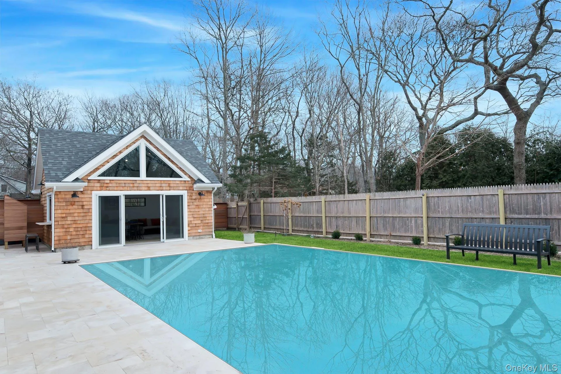 View of swimming pool with a fenced backyard, a patio, an outdoor structure, and an exterior structure View of swimming pool with a fenced backyard, a patio, an outdoor structure, and an exterior structure