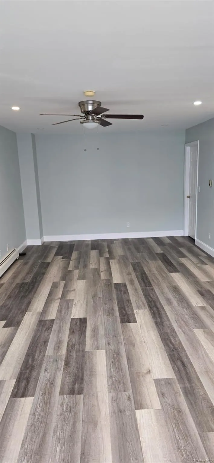 Unfurnished room featuring recessed lighting, light wood-type flooring, a baseboard heating unit, and ceiling fan Unfurnished room featuring recessed lighting, light wood-type flooring, a baseboard heating unit, and ceiling fan