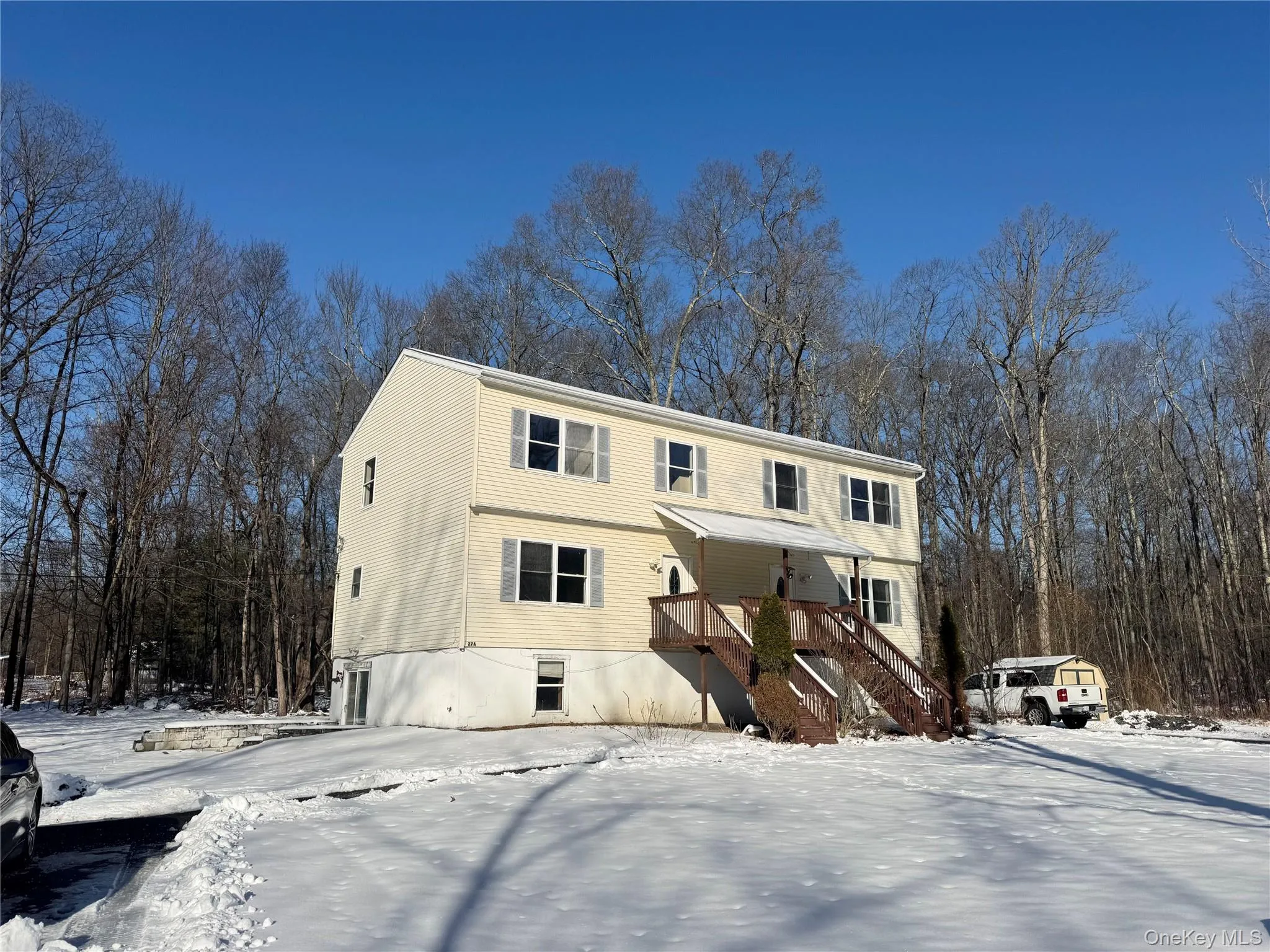 View of front facade featuring stairway and covered porch View of front facade featuring stairway and covered porch