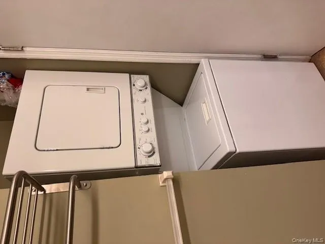 Laundry area with stacked washer and clothes dryer Laundry area with stacked washer and clothes dryer