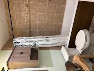 Bathroom featuring shower / bath combo with shower curtain and vanity Bathroom featuring shower / bath combo with shower curtain and vanity