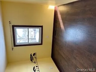 Empty room featuring dark wood-style floors Empty room featuring dark wood-style floors