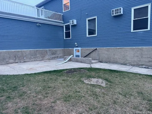 View of home's exterior with a lawn and a patio View of home's exterior with a lawn and a patio