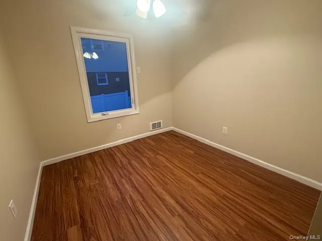 Bonus room featuring a ceiling fan and dark wood-style flooring Bonus room featuring a ceiling fan and dark wood-style flooring