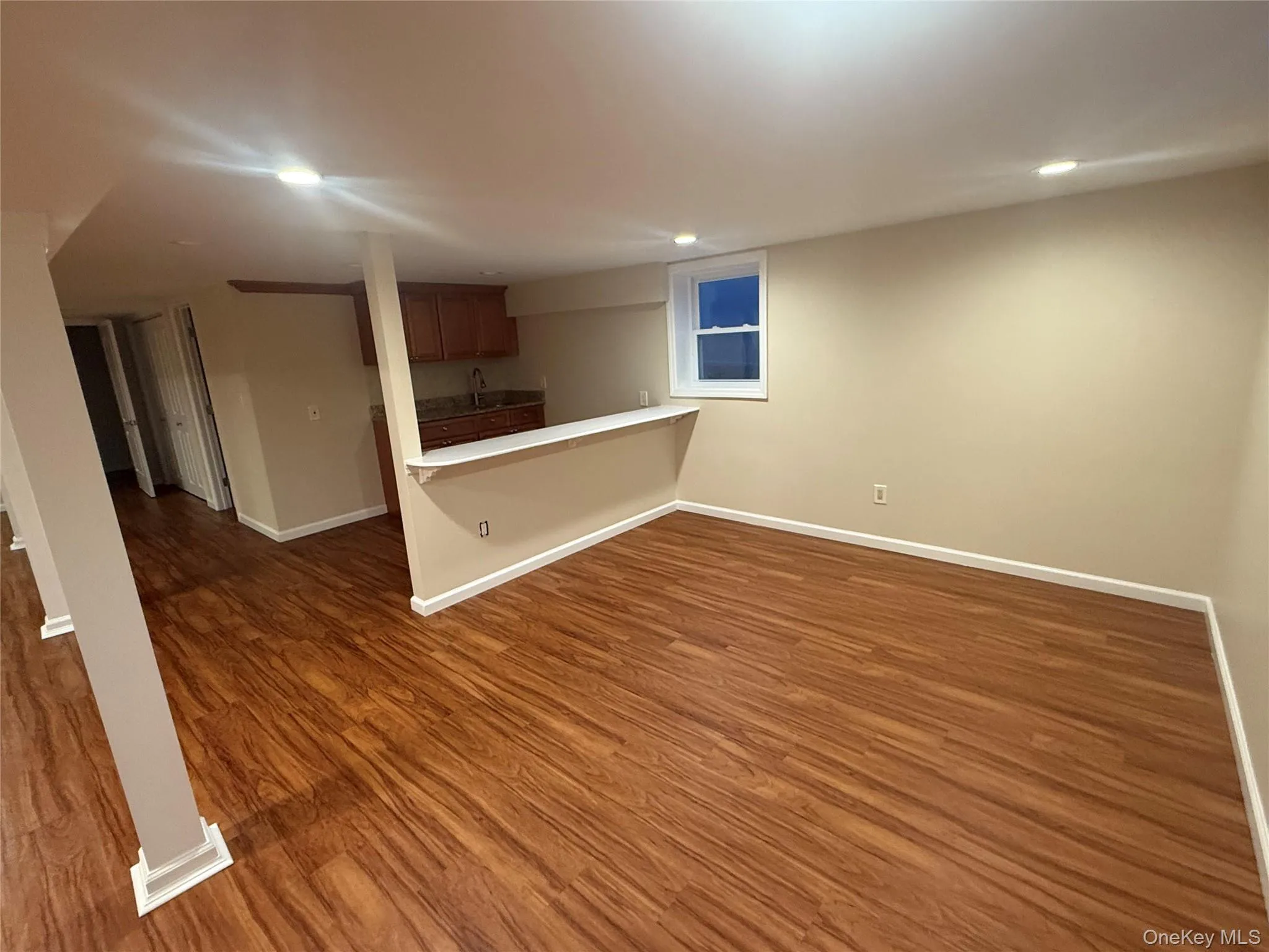 Unfurnished living room featuring recessed lighting and dark wood-type flooring Unfurnished living room featuring recessed lighting and dark wood-type flooring
