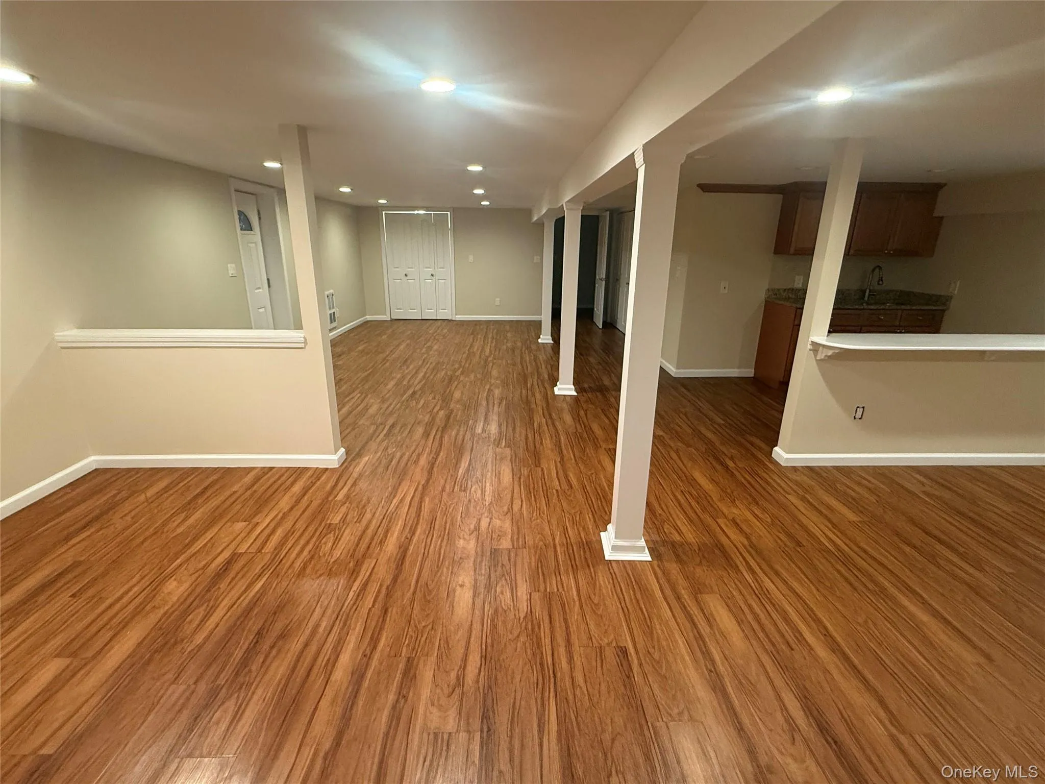 Finished below grade area featuring recessed lighting and dark wood-style flooring Finished below grade area featuring recessed lighting and dark wood-style flooring