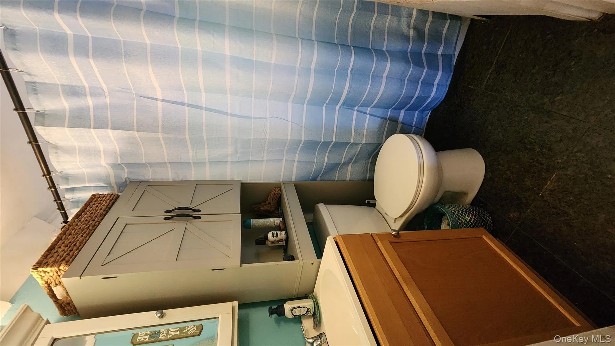 Full bathroom with vanity, a shower with curtain, and dark tile patterned floors Full bathroom with vanity, a shower with curtain, and dark tile patterned floors