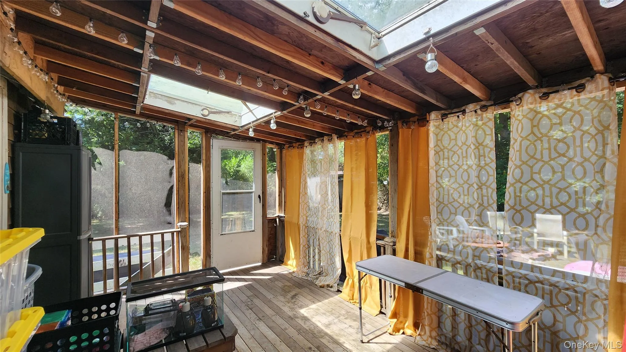 Sunroom featuring a skylight and plenty of natural light Sunroom featuring a skylight and plenty of natural light