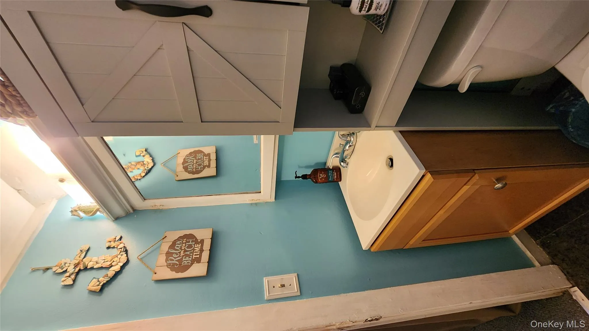 Bathroom featuring vanity and dark tile patterned flooring Bathroom featuring vanity and dark tile patterned flooring