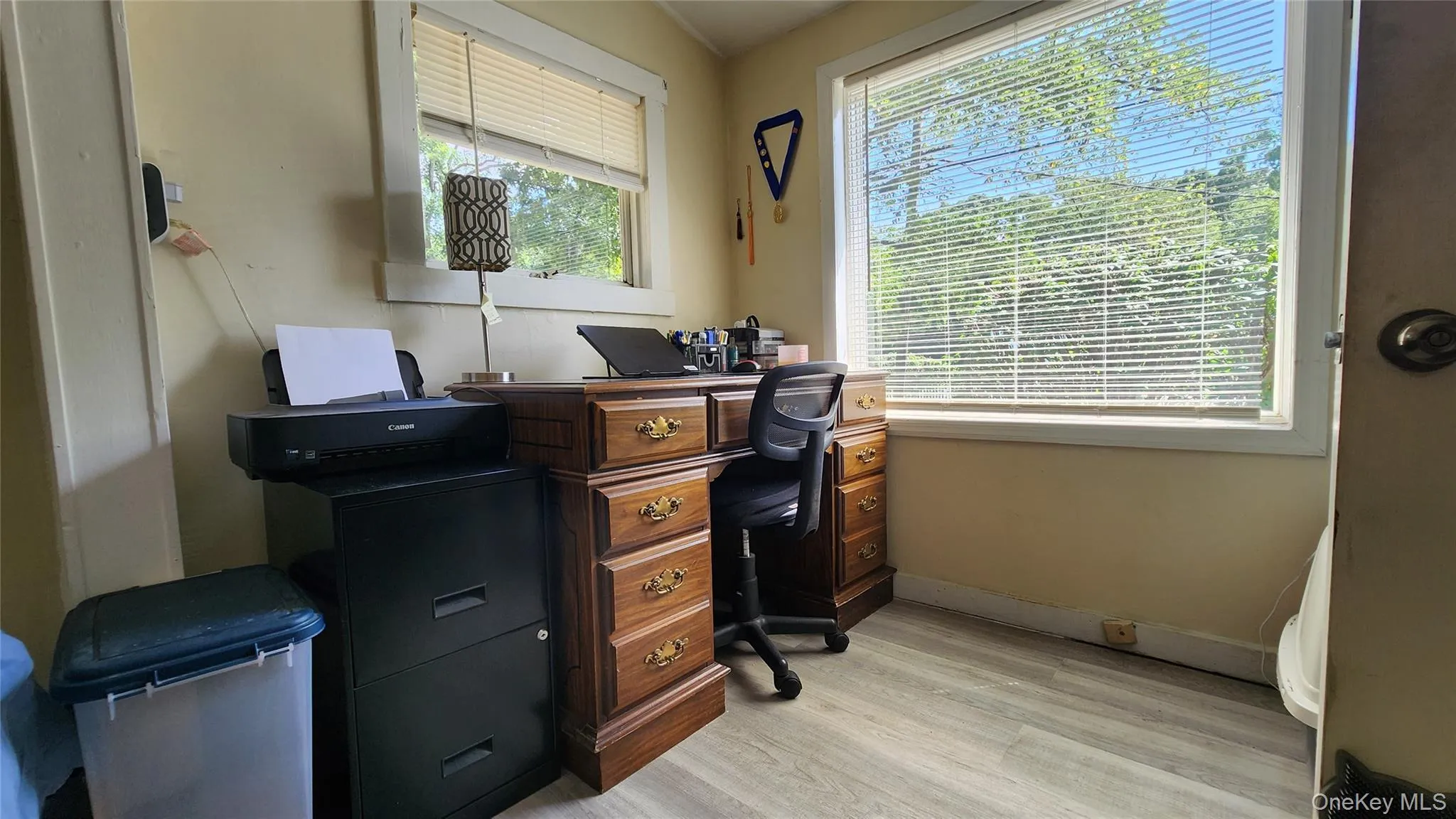 Office area with light wood-style floors and baseboards Office area with light wood-style floors and baseboards