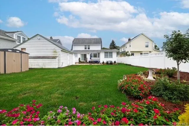 Rear view of house with a storage unit, a fenced backyard, and a patio Rear view of house with a storage unit, a fenced backyard, and a patio